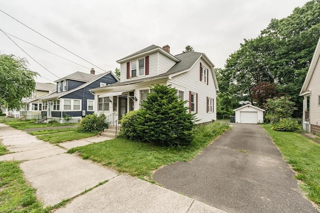 71 Daviston St, Springfield, MA 01108 - view of front facade with a detached garage, an outdoor structure, a chimney, driveway, and a front lawn
