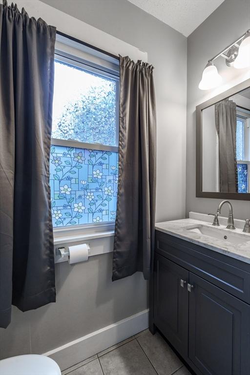 71 Daviston St, Springfield, MA 01108 - bathroom with tile patterned floors, vanity, baseboards, and toilet