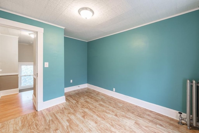71 Daviston St, Springfield, MA 01108 - unfurnished room with wood finished floors, crown molding, radiator heating unit, and baseboards