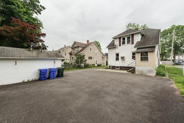 71 Daviston St, Springfield, MA 01108 - rear view of property featuring entry steps, a chimney, and roof with shingles