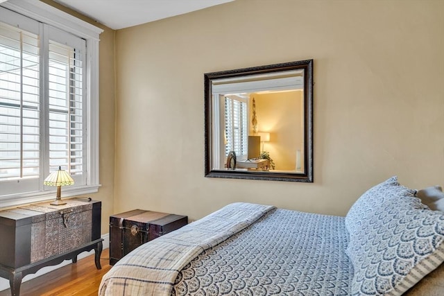 bedroom featuring multiple windows and hardwood / wood-style floors