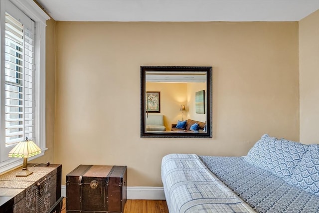 bedroom featuring multiple windows and hardwood / wood-style floors