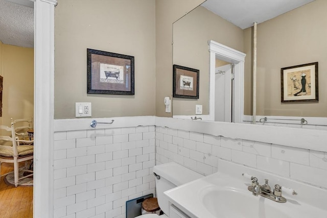 bathroom with vanity, wood-type flooring, tile walls, and toilet