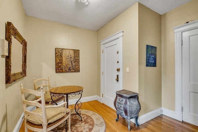 living area featuring hardwood / wood-style floors and a textured ceiling