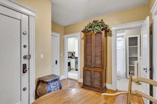 interior space with light hardwood / wood-style flooring and a textured ceiling