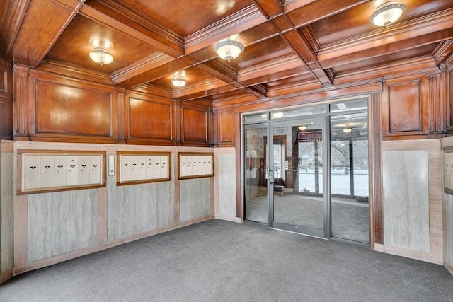 carpeted empty room with wood ceiling, coffered ceiling, mail boxes, and crown molding