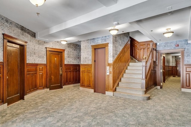 interior space with light carpet and elevator