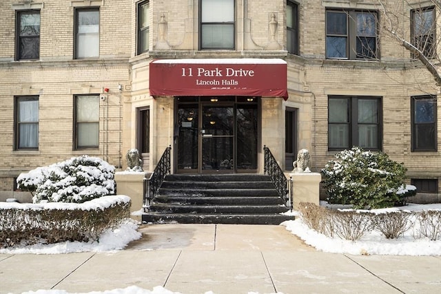 view of snow covered property entrance