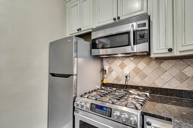 kitchen featuring backsplash, dark stone counters, and appliances with stainless steel finishes