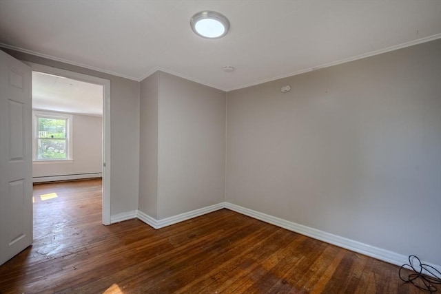 empty room with a baseboard radiator, hardwood / wood-style floors, crown molding, and baseboards