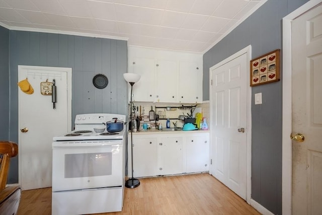 kitchen featuring white range with electric stovetop, white cabinetry, light wood-style flooring, and light countertops