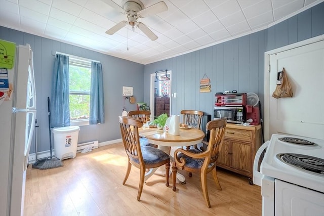 dining area with light wood finished floors, baseboard heating, and ceiling fan