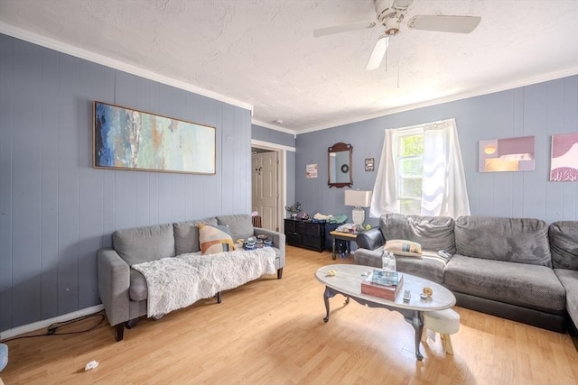 living area with light wood-style flooring, ornamental molding, and ceiling fan