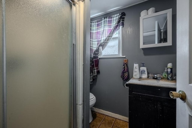 full bath featuring a shower stall, vanity, tile patterned floors, and toilet