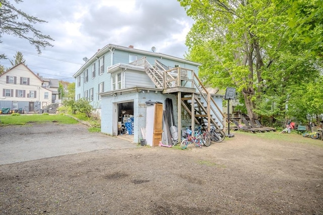 back of property with stairs and a deck