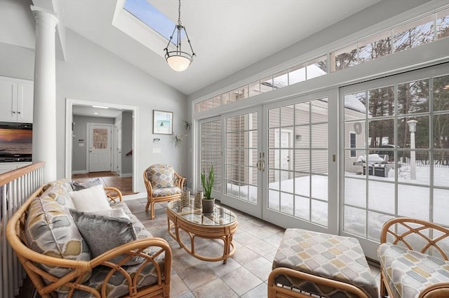 interior space with a skylight, high vaulted ceiling, and french doors