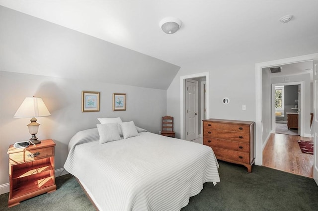 bedroom with lofted ceiling, baseboards, visible vents, and carpet flooring