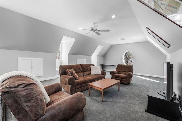 living area featuring visible vents, baseboards, lofted ceiling with skylight, carpet, and recessed lighting