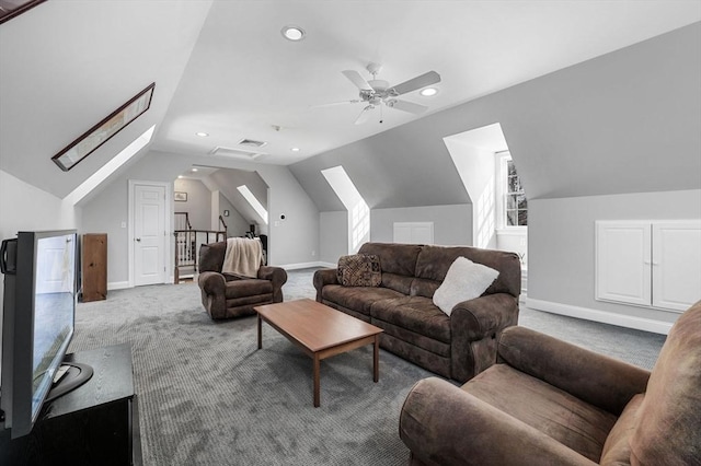 living room with lofted ceiling with skylight, carpet, ceiling fan, and baseboards