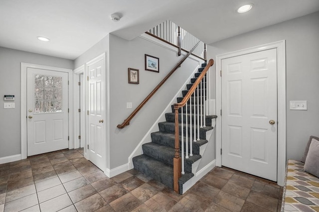 entrance foyer with stairway, baseboards, and recessed lighting