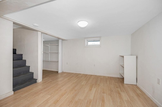 basement with light hardwood / wood-style flooring