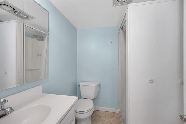 bathroom featuring tile patterned flooring, vanity, curtained shower, and toilet