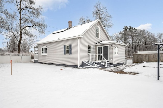 view of snow covered rear of property