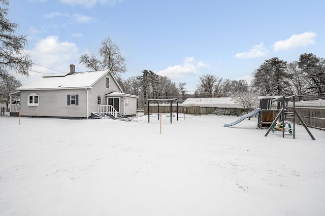 snowy yard with a playground