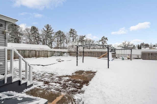 snowy yard with a playground