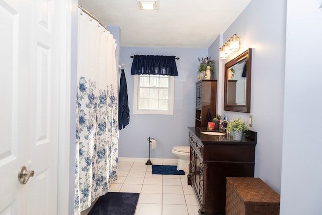 bathroom featuring tile patterned flooring, vanity, and toilet