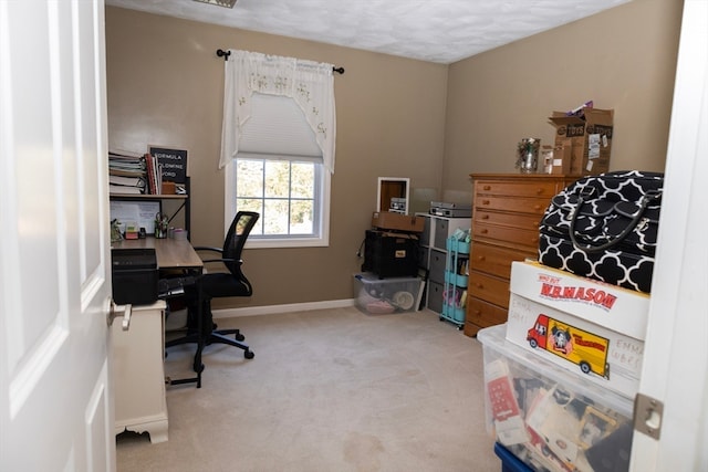 carpeted office featuring a textured ceiling