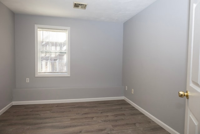 spare room featuring dark wood-type flooring