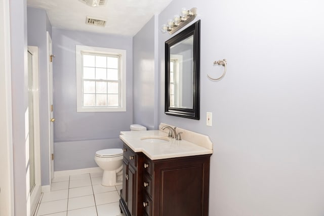 bathroom featuring toilet, vanity, tile patterned floors, and walk in shower