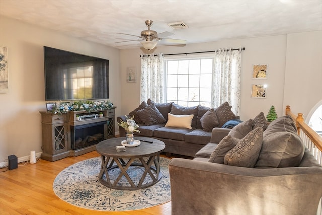 living room with ceiling fan and hardwood / wood-style floors