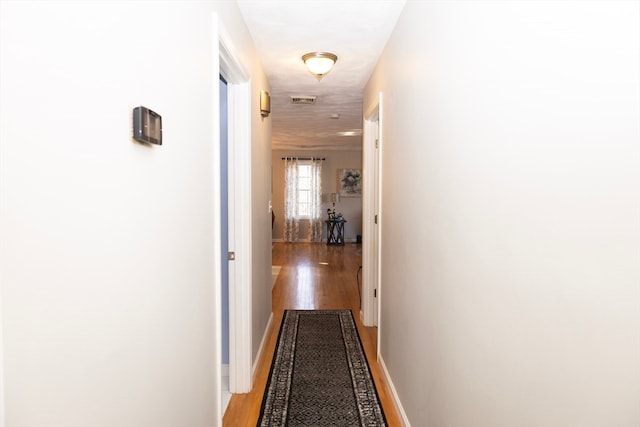 hallway featuring hardwood / wood-style floors