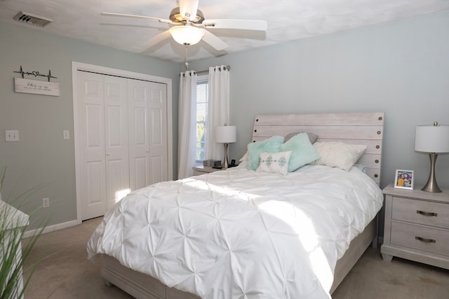 carpeted bedroom featuring a closet and ceiling fan