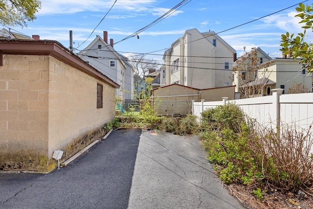 view of side of home with a patio and fence