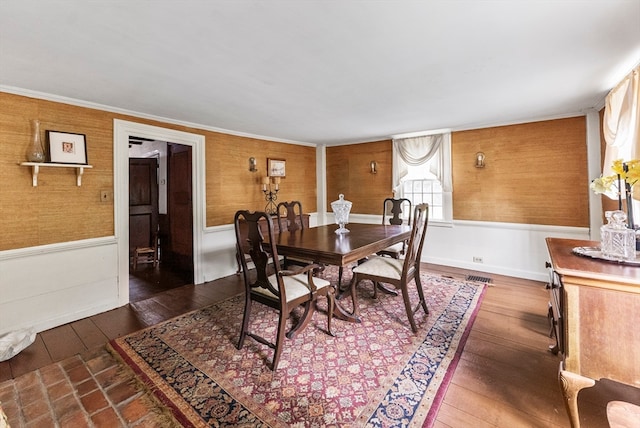 dining space featuring dark hardwood / wood-style floors and crown molding