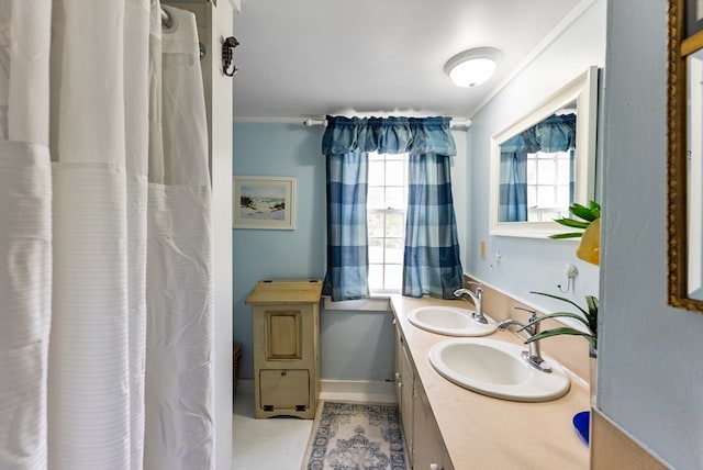 bathroom with tile patterned floors, crown molding, and vanity