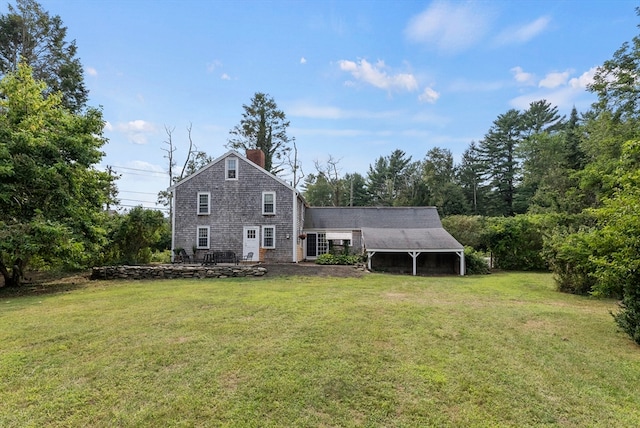 rear view of house featuring a yard