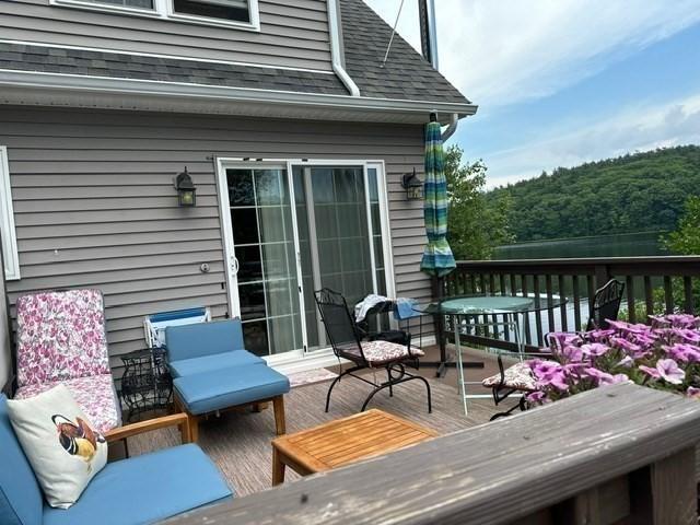 wooden deck with an outdoor living space