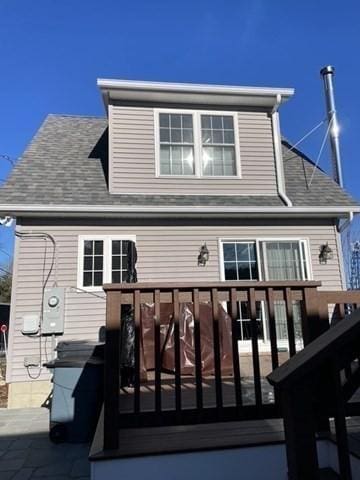 rear view of house featuring a deck