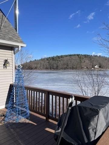 deck with a grill and a water view