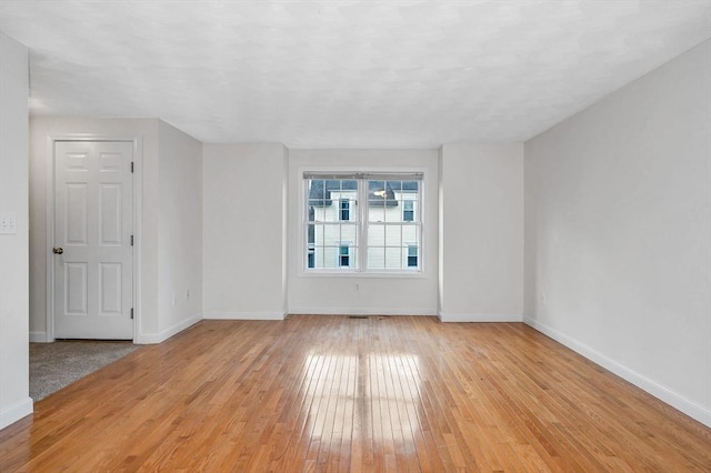 unfurnished room with light hardwood / wood-style flooring