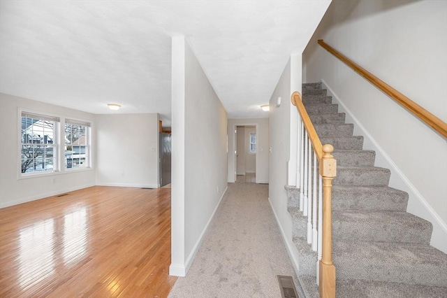 staircase featuring wood-type flooring