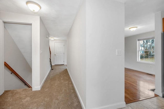 corridor featuring light colored carpet