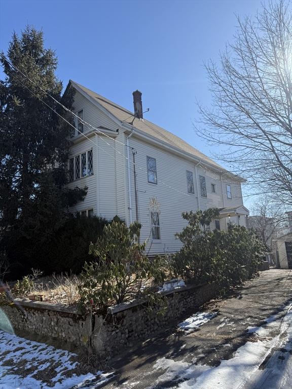 view of side of home featuring a chimney