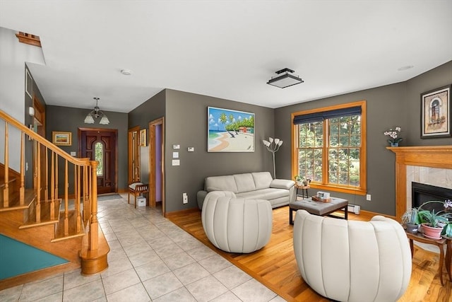 294 Cardinal Way, Northampton, MA 01062 - living room with stairway, a premium fireplace, light tile patterned floors, and baseboard heating
