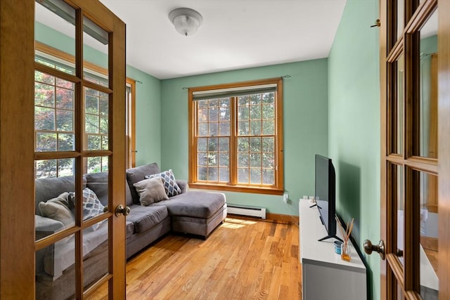 294 Cardinal Way, Northampton, MA 01062 - living area with baseboard heating, french doors, and light wood-type flooring