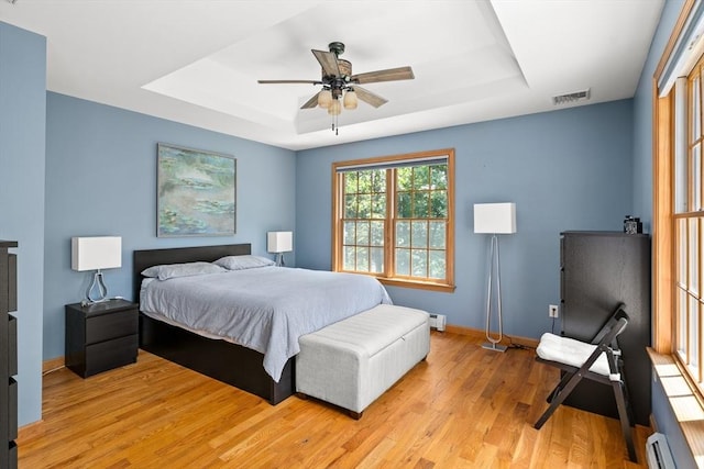 294 Cardinal Way, Northampton, MA 01062 - bedroom with a raised ceiling, light wood-style flooring, a baseboard heating unit, and ceiling fan